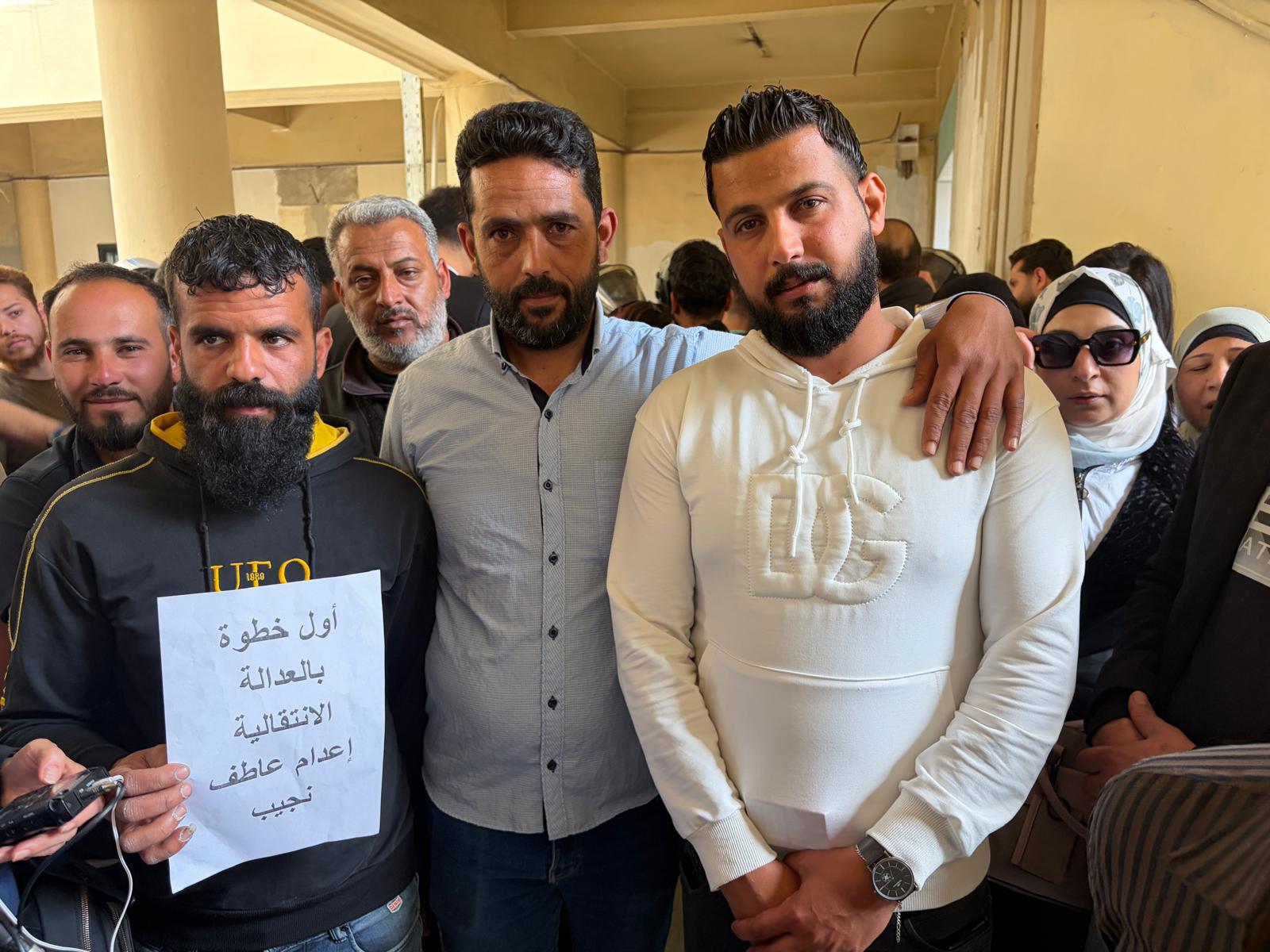 Mouawiya Syasneh, Yousef Swedan and Ebraheem Rshedat (right to left), standing in a crowd